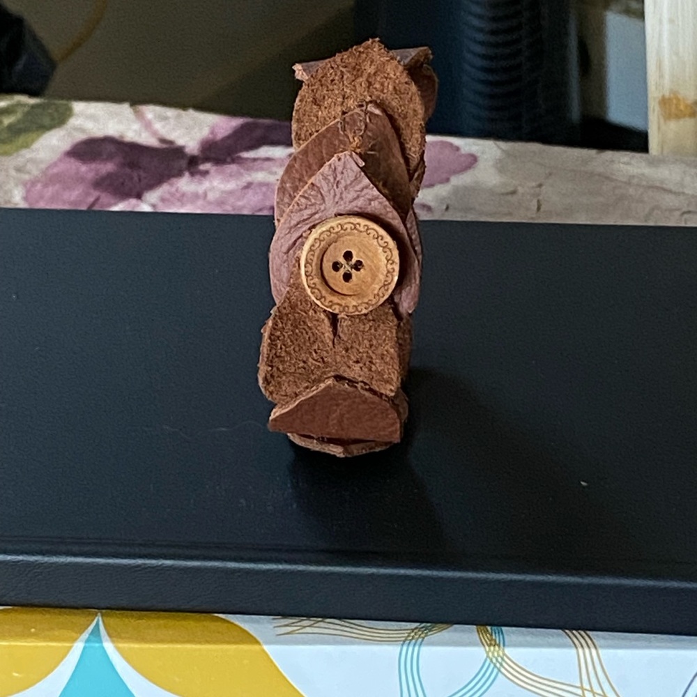 Leather leaf bracelet.  It buttons in size 7 1/2 it is brown.